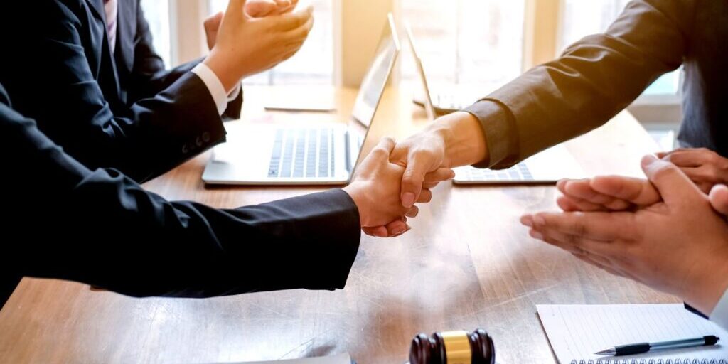 Businessman shaking hands to seal a deal with his partner lawyers or attorneys discussing a contract agreement (Businessman shaking hands to seal a deal with his partner lawyers or attorneys discussing a contract agreement, ASCII, 111 components, 111